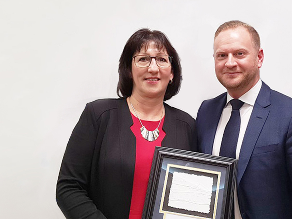 picture of man and woman holding an award