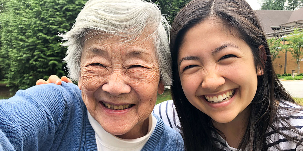 Grandmother in 90s Taking Selfie with Granddaughter Outside Retirement Home